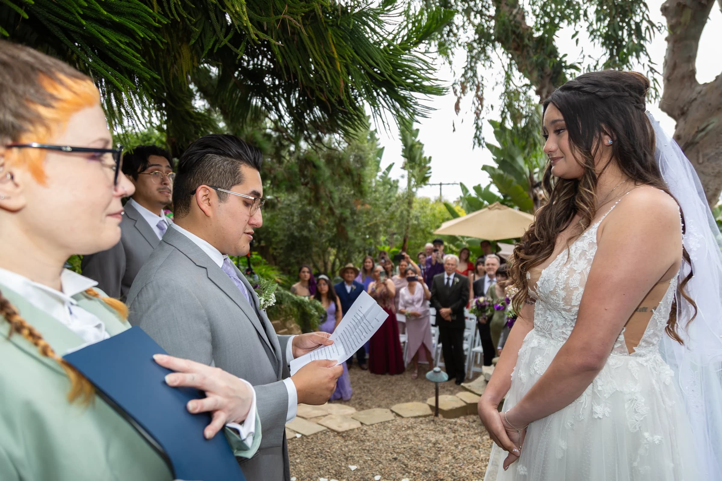 A groom reads his vows to his bride during an intimate garden ceremony